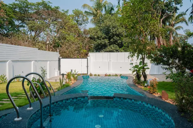 Private pool with steps and a lawn beside it